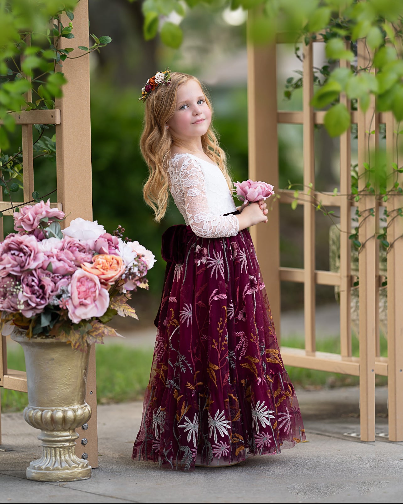 Toddler girl wearing white lace and burgundy floral embroidered  flower girl dress