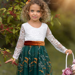 Close-up of floral embroidered hunter green tulle on long sleeve dress