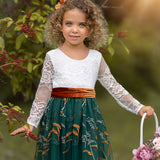 Close-up of floral embroidered hunter green tulle on long sleeve dress