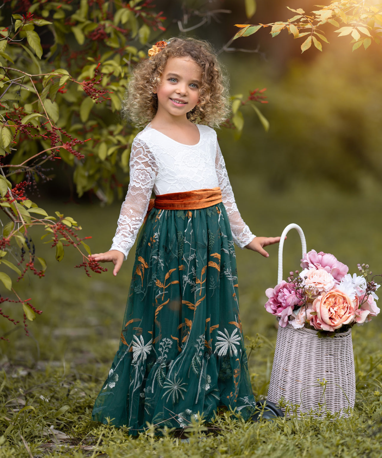Toddler girl wearing white lace and hunter green flower girl dress