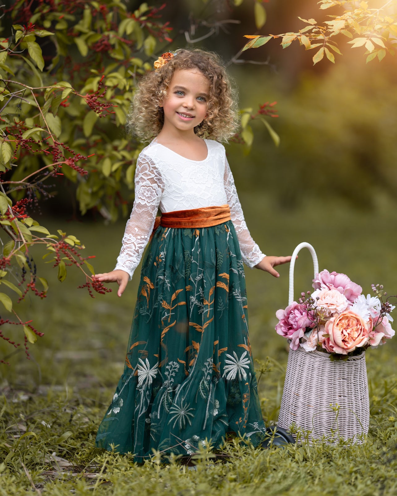 Toddler girl wearing white lace and hunter green flower girl dress