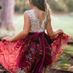 Close-up of knee-length burgundy tulle skirt with embroidered florals