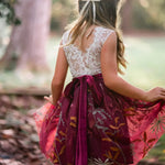 Back view of white lace and burgundy velvet sash with floral embroidery