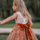 Detailed view of embroidered tulle skirt with fall florals and velvet sash on flower girl dress