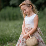 Toddler girl posing in floral embroidered champagne tulle dress with velvet sash