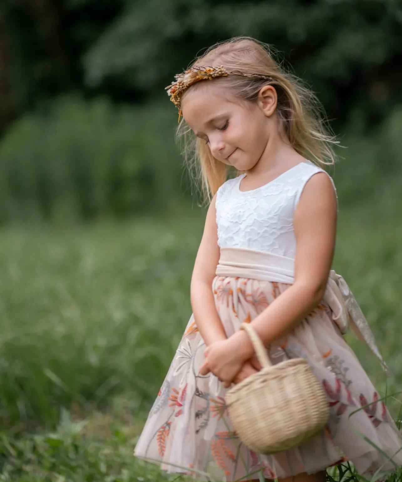 Toddler girl posing in floral embroidered champagne tulle dress with velvet sash