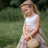 Toddler girl posing in floral embroidered champagne tulle dress with velvet sash