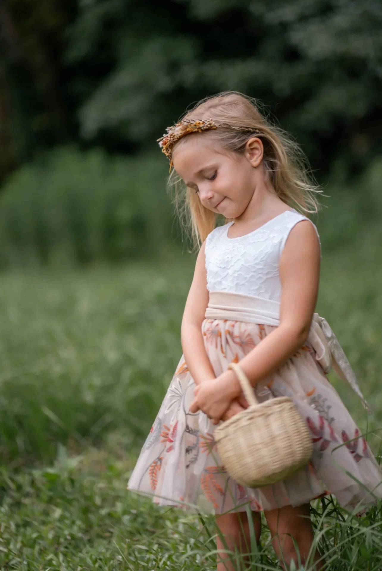 Toddler girl posing in floral embroidered champagne tulle dress with velvet sash