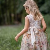 Back view of sleeveless flower girl dress with V-shaped lace and embroidered tulle